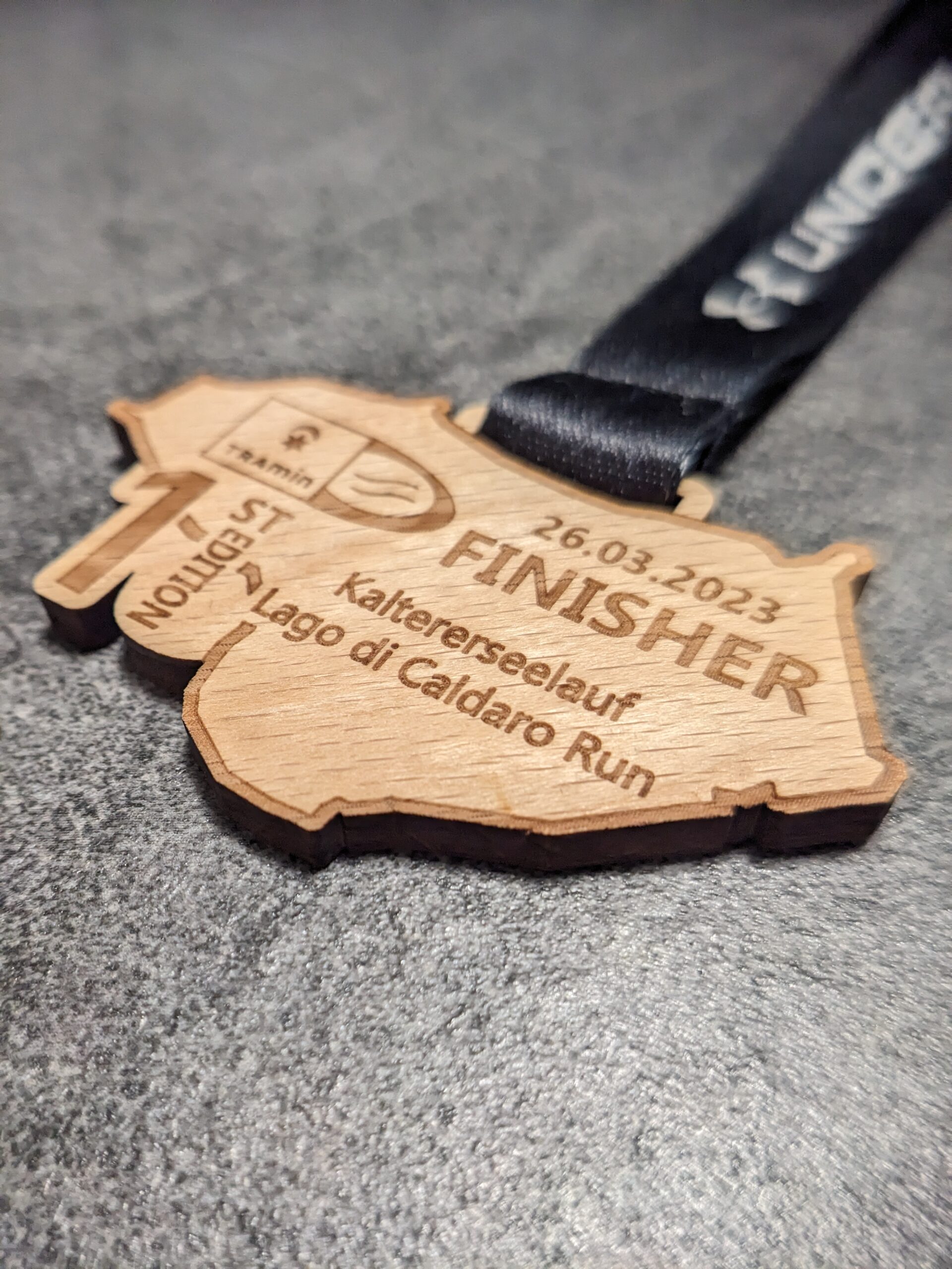 custom caldaro lake half marathon medal natural wood laser cut and engraved with personalized sublimation ribbon side view custom caldaro lake half marathon medal natural wood laser cut and engraved with personalized sublimation ribbon side view