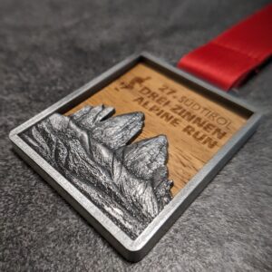 custom drei zinnen - 3 peaks alpine run wood and metal 3D embossed medal antique silver finish with personalized sublimation ribbon side view
