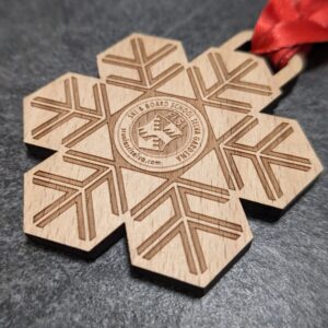 custom ski school selva medal made of natural laser cut and engraved wood with personalized sublimation ribbon side view
