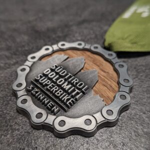 custom südtirol dolomites superbike wood and metal 3D relief medal antique silver finish with personalized silk screen ribbon side view