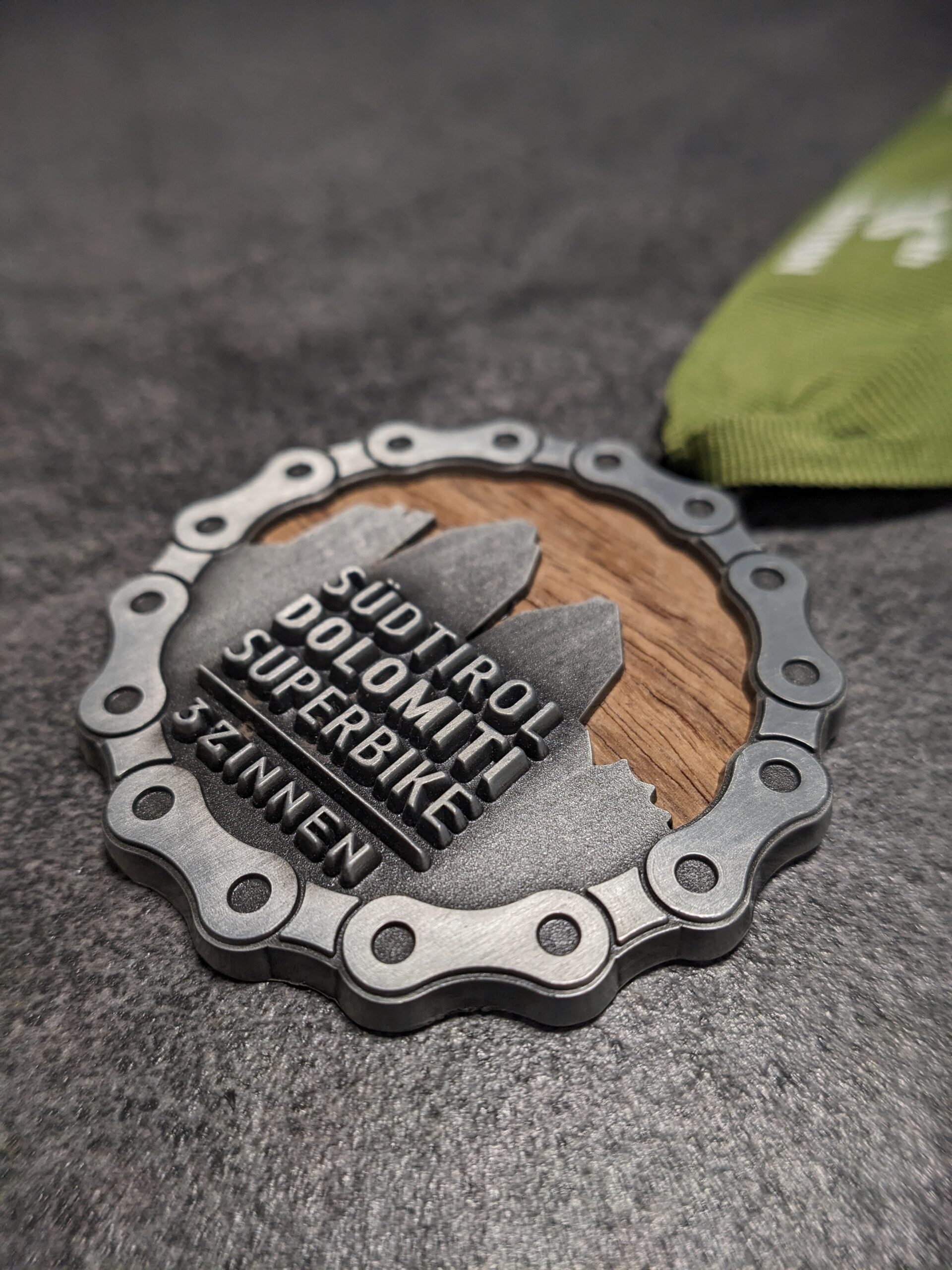 custom südtirol dolomites superbike wood and metal 3D relief medal antique silver finish with personalized silk screen ribbon side view custom südtirol dolomites superbike wood and metal 3D relief medal antique silver finish with personalized silk screen ribbon side view