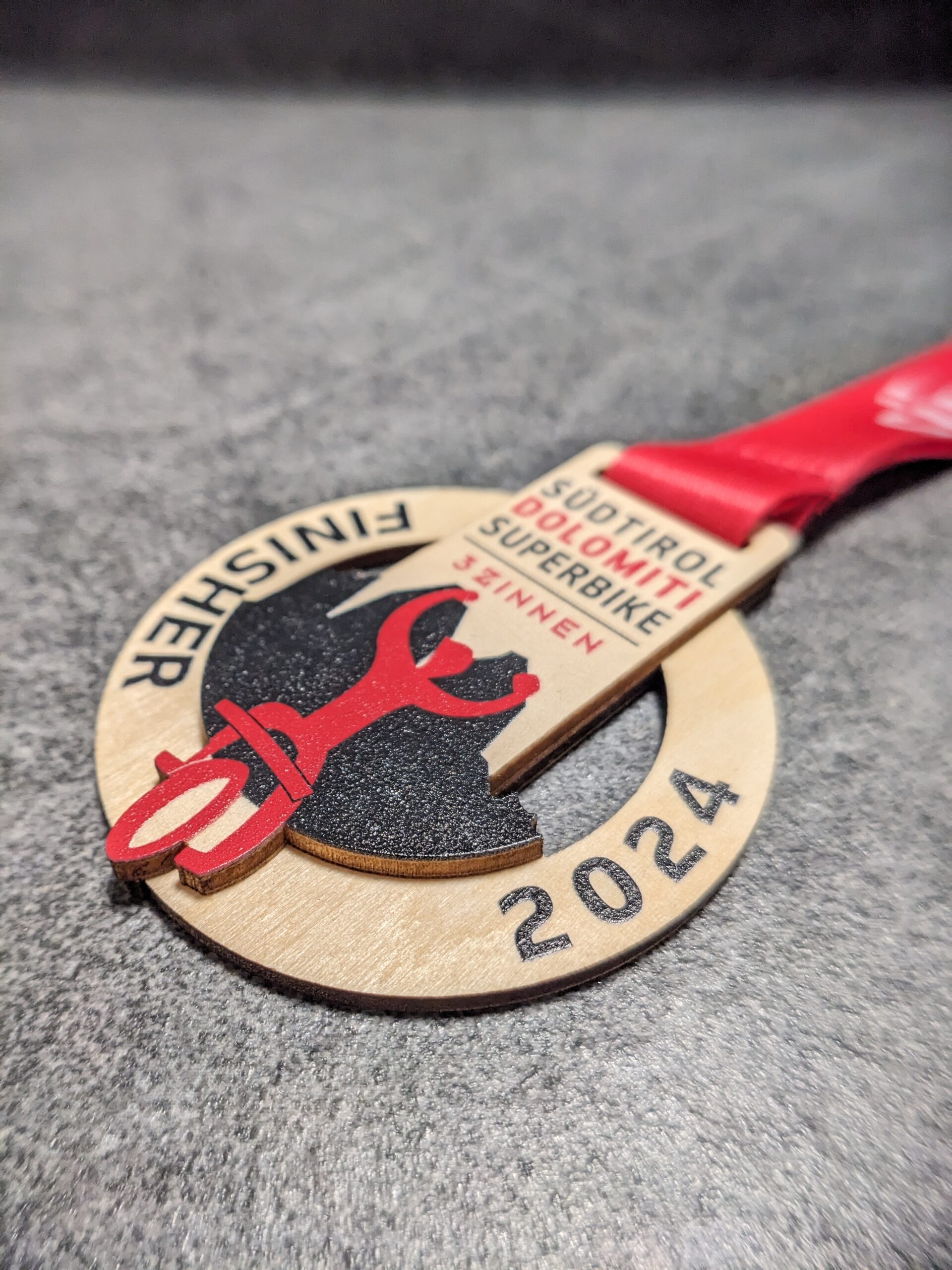 custom südtirol dolomiti superbike medal made of natural wood laser cut and uv printed with stacked layers with personalized sublimation ribbon side view custom südtirol dolomiti superbike medal made of natural wood laser cut and uv printed with stacked layers with personalized sublimation ribbon side view